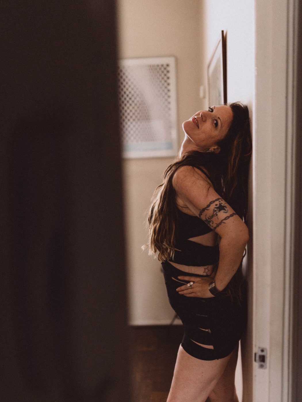 Ariella leaning in a doorway